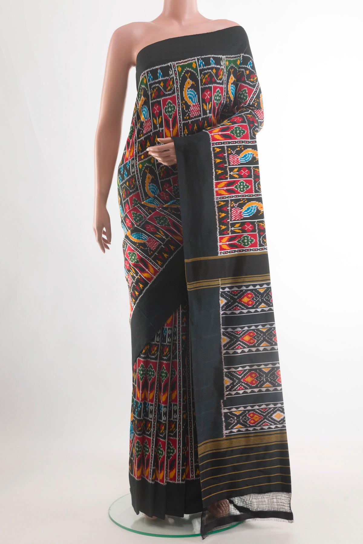 Black Pochampally Silk Saree with Pure Ikat on the body and Ikat Border.  displayed on a mannequin