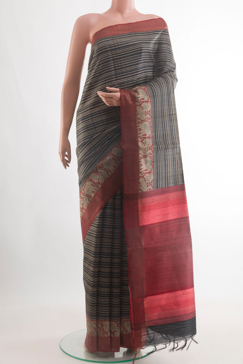 Black Tussar Silk Saree with Stripes on the body and Zari Border.  displayed on a mannequin