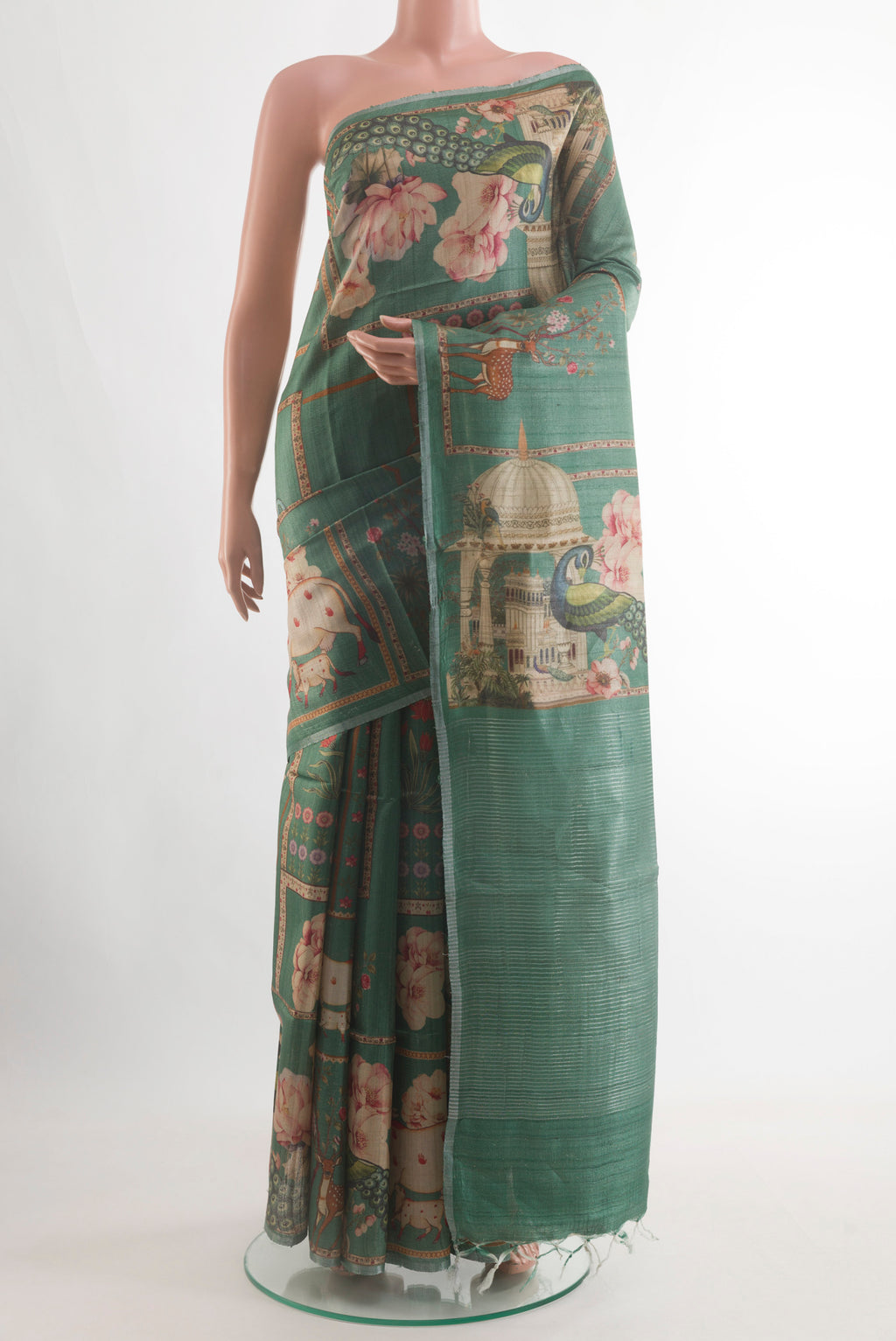 Green Tussar Silk Saree with Printed design on the body and Zari Border.  displayed on a mannequin