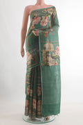 Green Tussar Silk Saree with Printed design on the body and Zari Border.  displayed on a mannequin