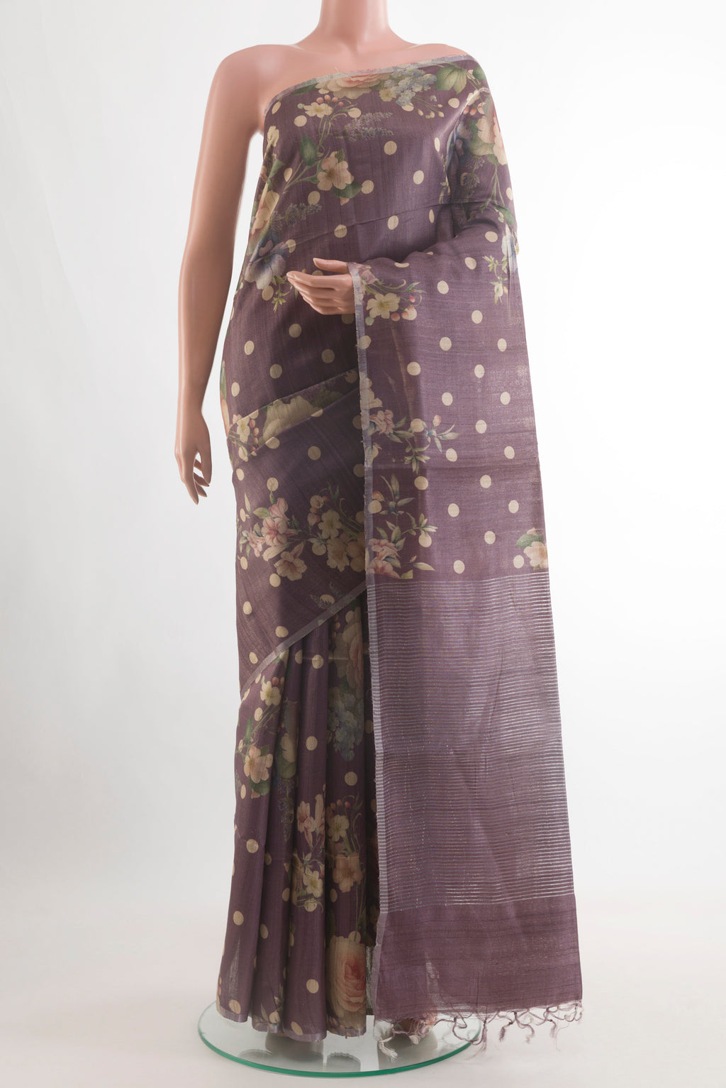 Lilac Tussar Silk Saree with Floral Print on the body and Zari Border.  displayed on a mannequin