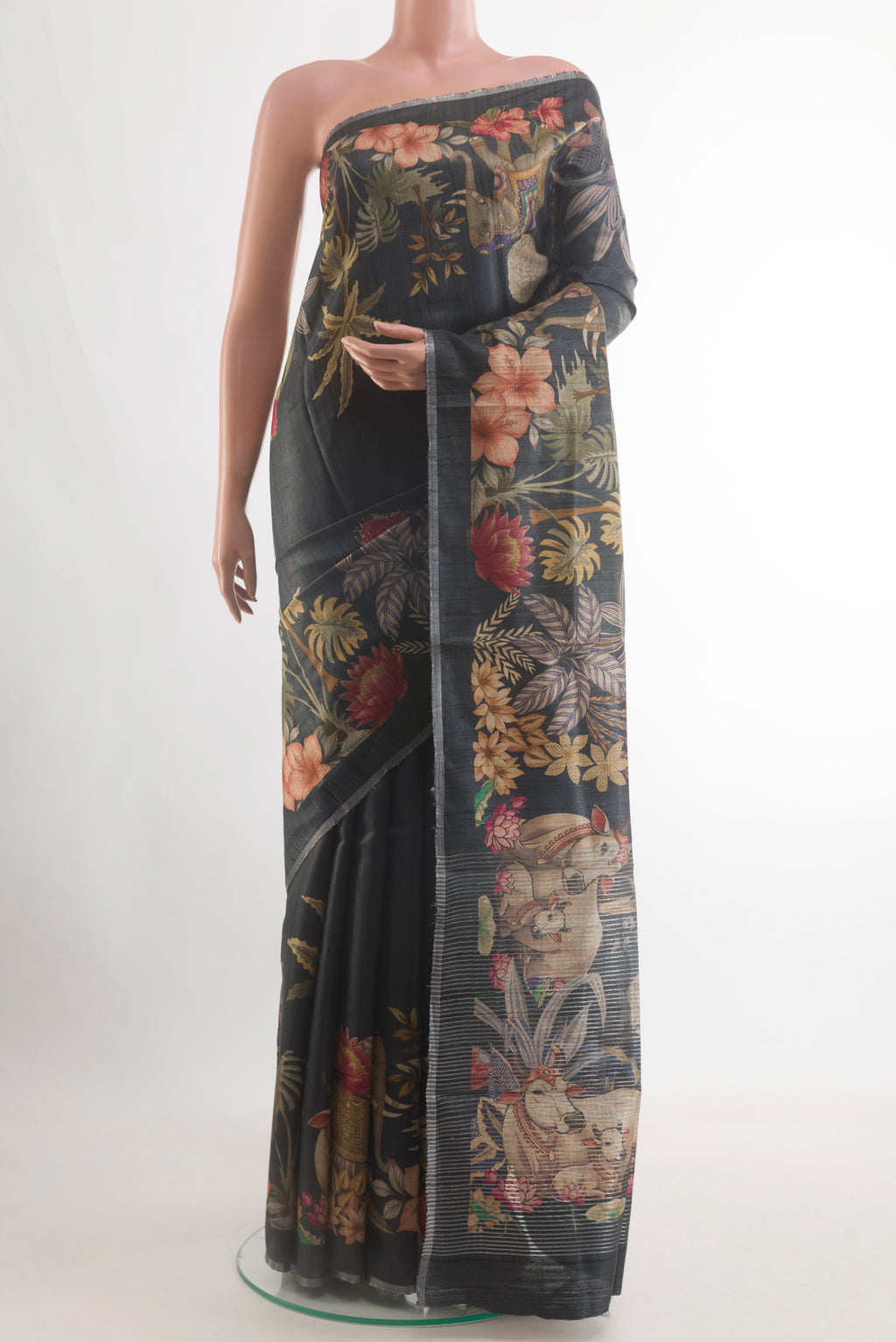 Black Tussar Silk Saree with Printed design on the body and Zari Border.  displayed on a mannequin