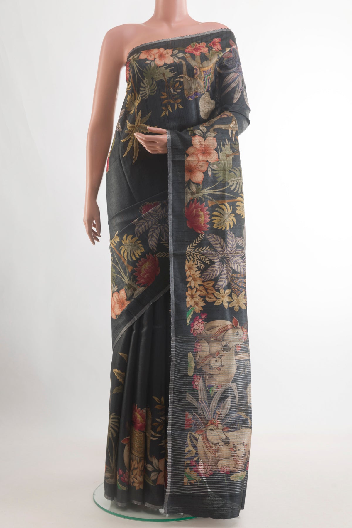 Black Tussar Silk Saree with Printed design on the body and Zari Border.  displayed on a mannequin