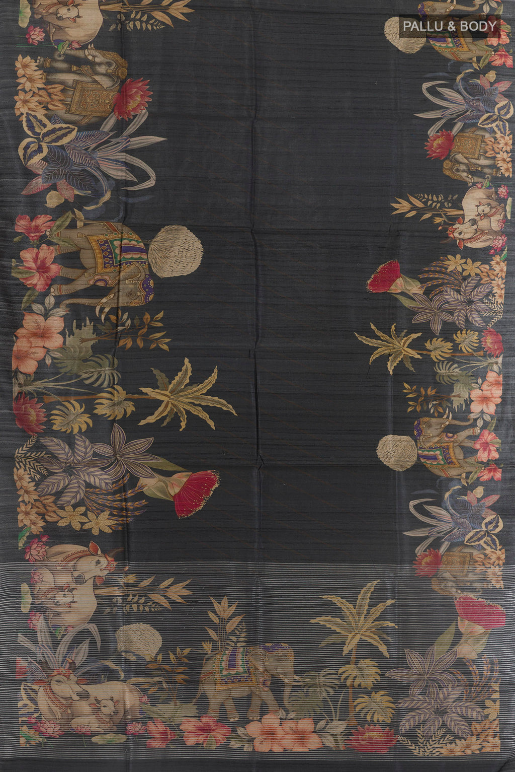 Flat view of Black Tussar Silk Saree with Printed design on the body and Zari Border. 