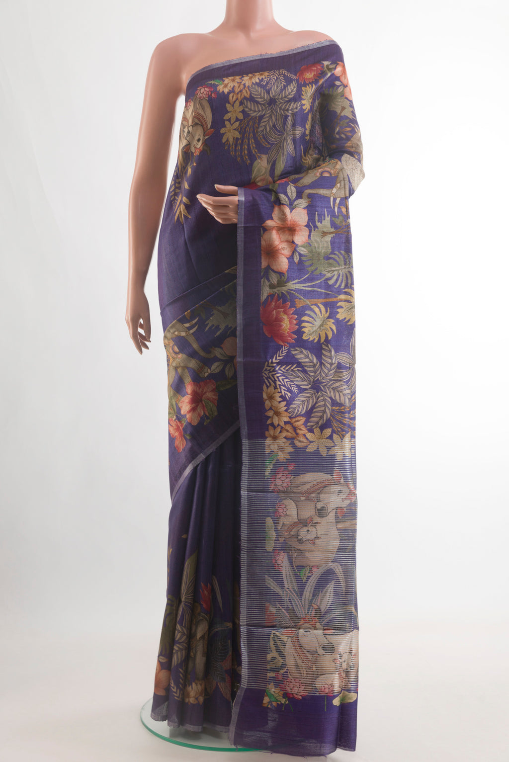 Violet Tussar Silk Saree with Printed design on the body and Zari Border.  displayed on a mannequin