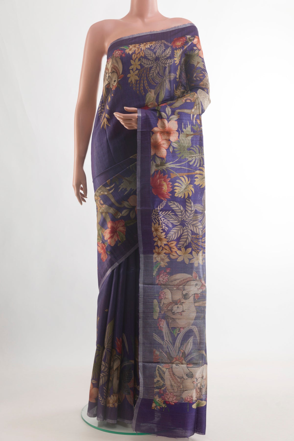 Violet Tussar Silk Saree with Printed design on the body and Zari Border.  displayed on a mannequin
