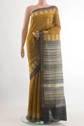 Mehandi Green Tussar Silk Saree with Batik Print on the body and Zari Border.  displayed on a mannequin