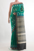 Teal Tussar Silk Saree with Batik Print on the body and Zari Border.  displayed on a mannequin