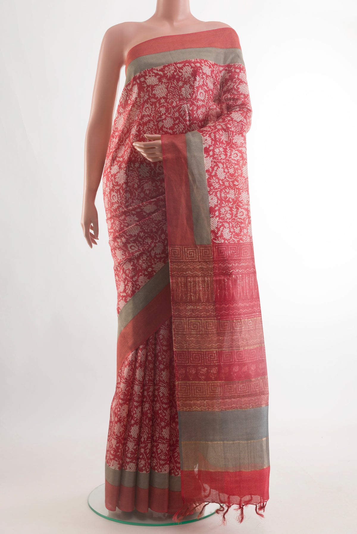 Red Tussar Silk Saree with Printed design on the body and Zari Border.  displayed on a mannequin
