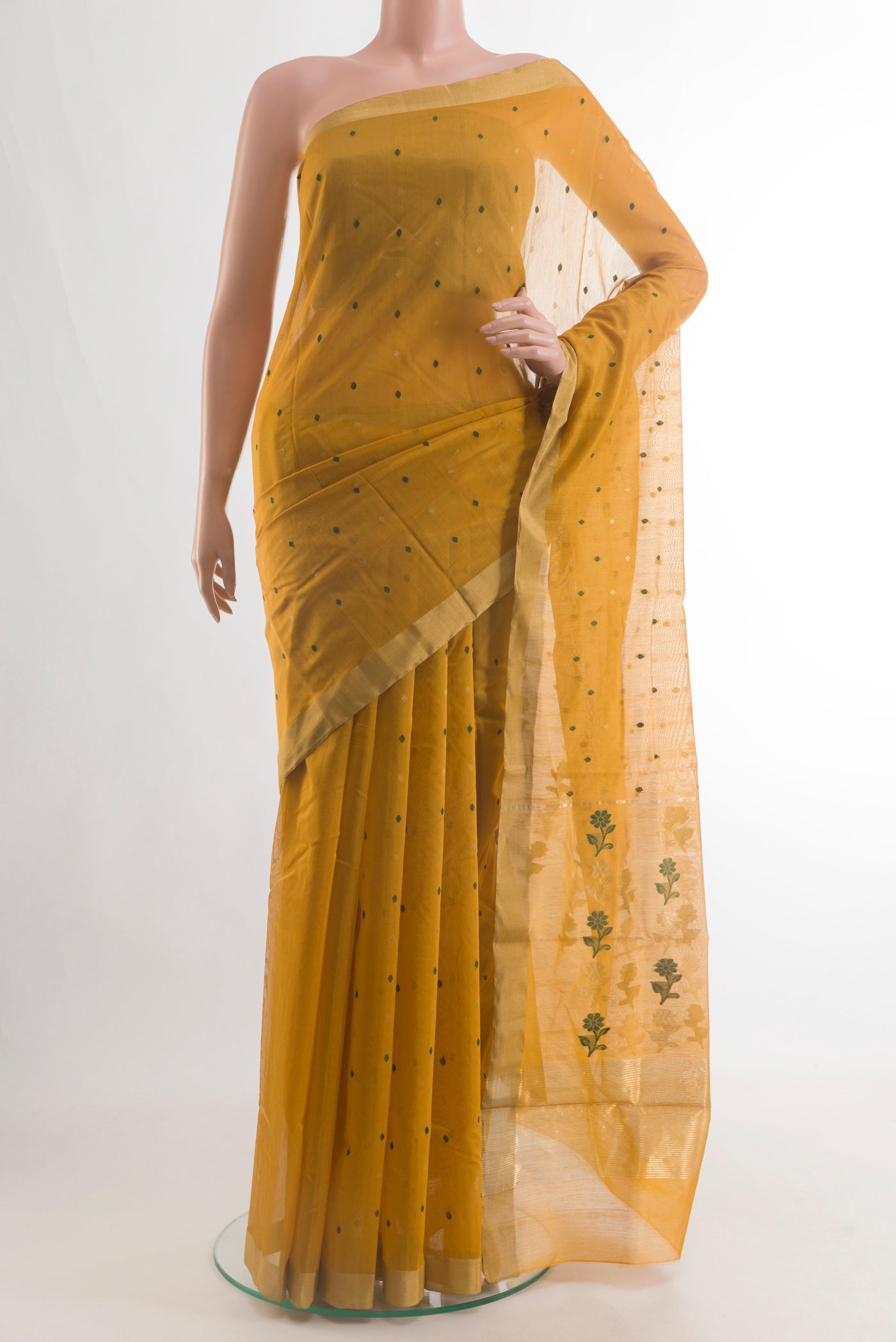 Mustard Chanderi Silk Cotton Saree with Zari And Thread Butta on the body and Zari Border.  displayed on a mannequin