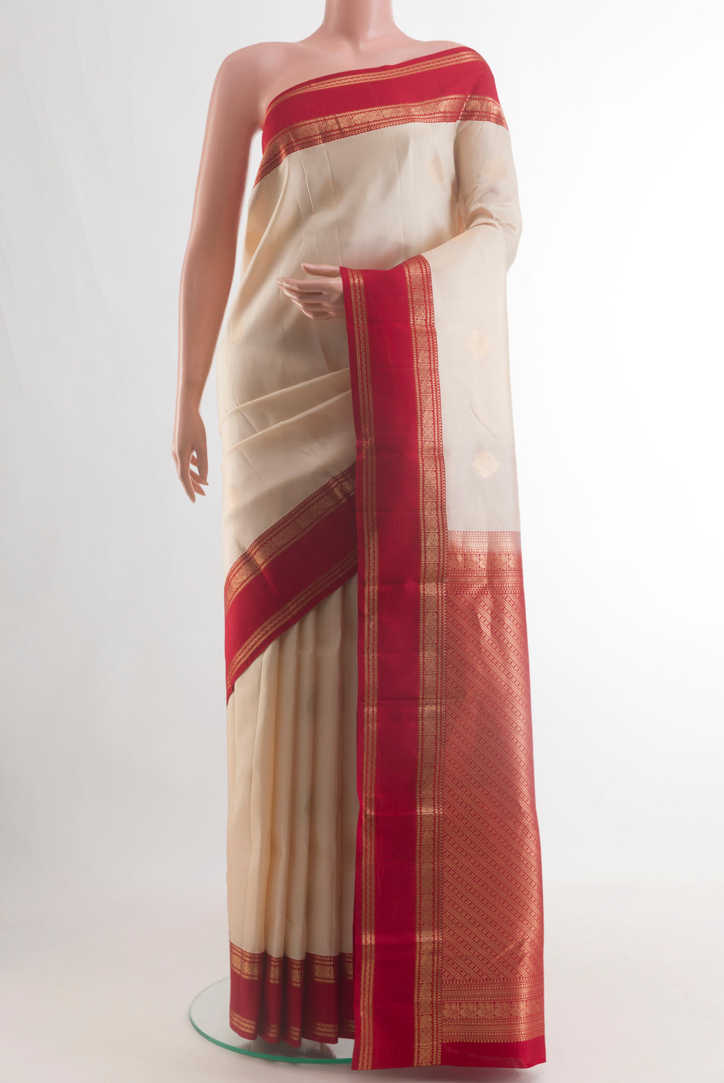 Pure Silk Off White Kanjivaram Saree with Zari Butta on the body and Zari Border.  displayed on a mannequin