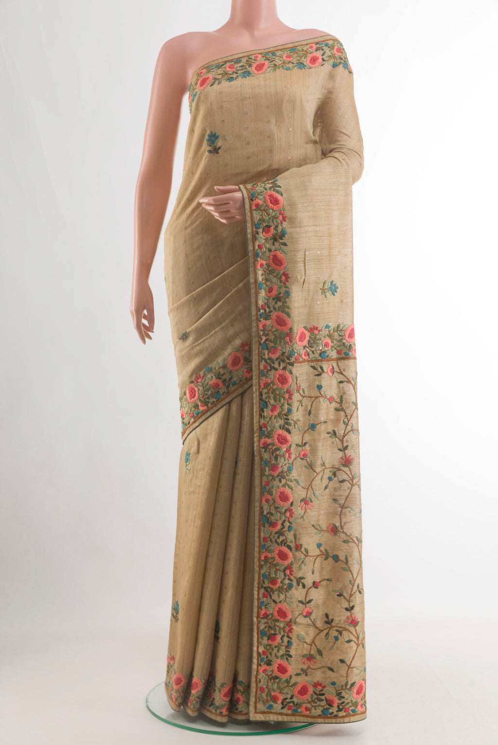 Beige Tussar Saree with Embroidery on the body and Zari Border.  displayed on a mannequin