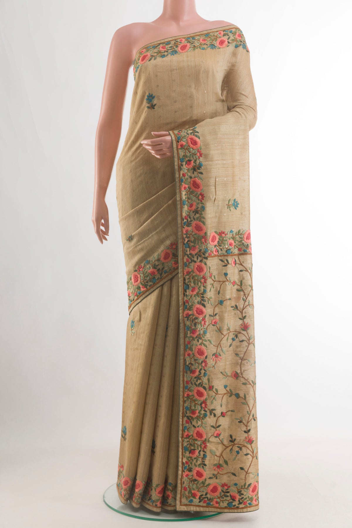 Beige Tussar Saree with Embroidery on the body and Zari Border.  displayed on a mannequin