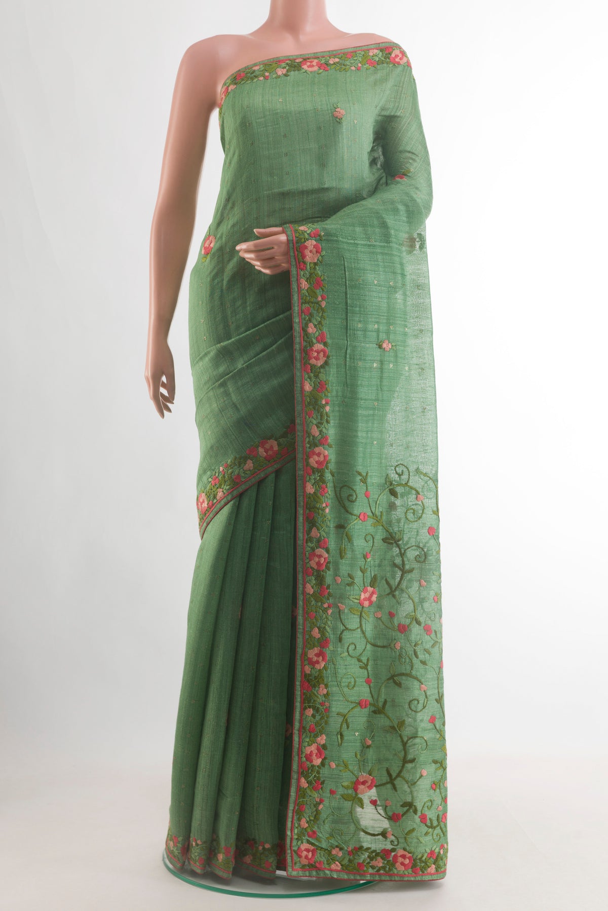 Green Tussar Saree with Embroidery on the body and Embroidery Border.  displayed on a mannequin