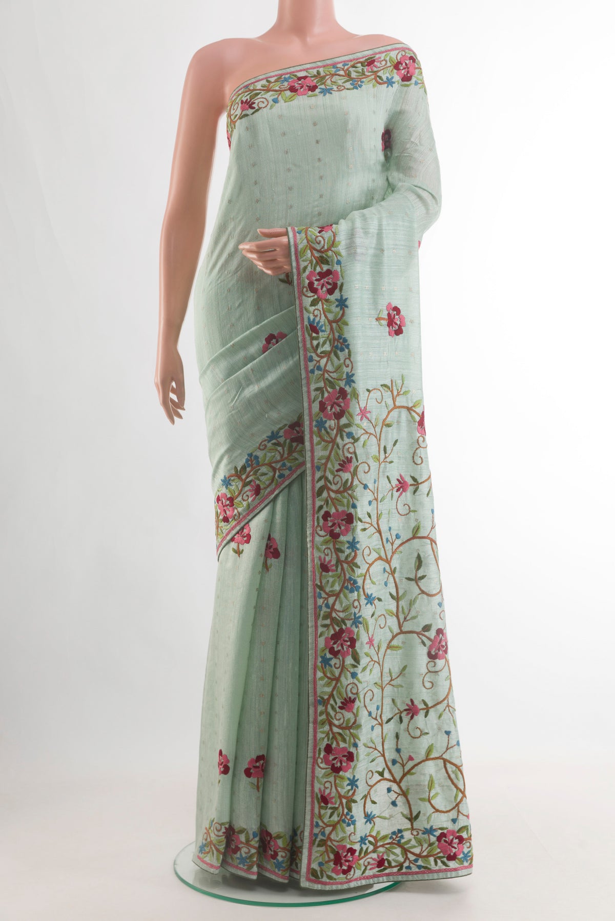 Light Blue Tussar Saree with Embroidery on the body and Embroidery Border.  displayed on a mannequin