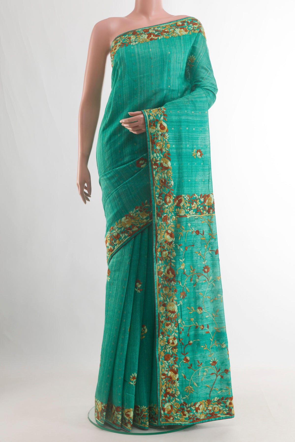 Sea Green Tussar Saree with Embroidery on the body and Embroidery Border.  displayed on a mannequin