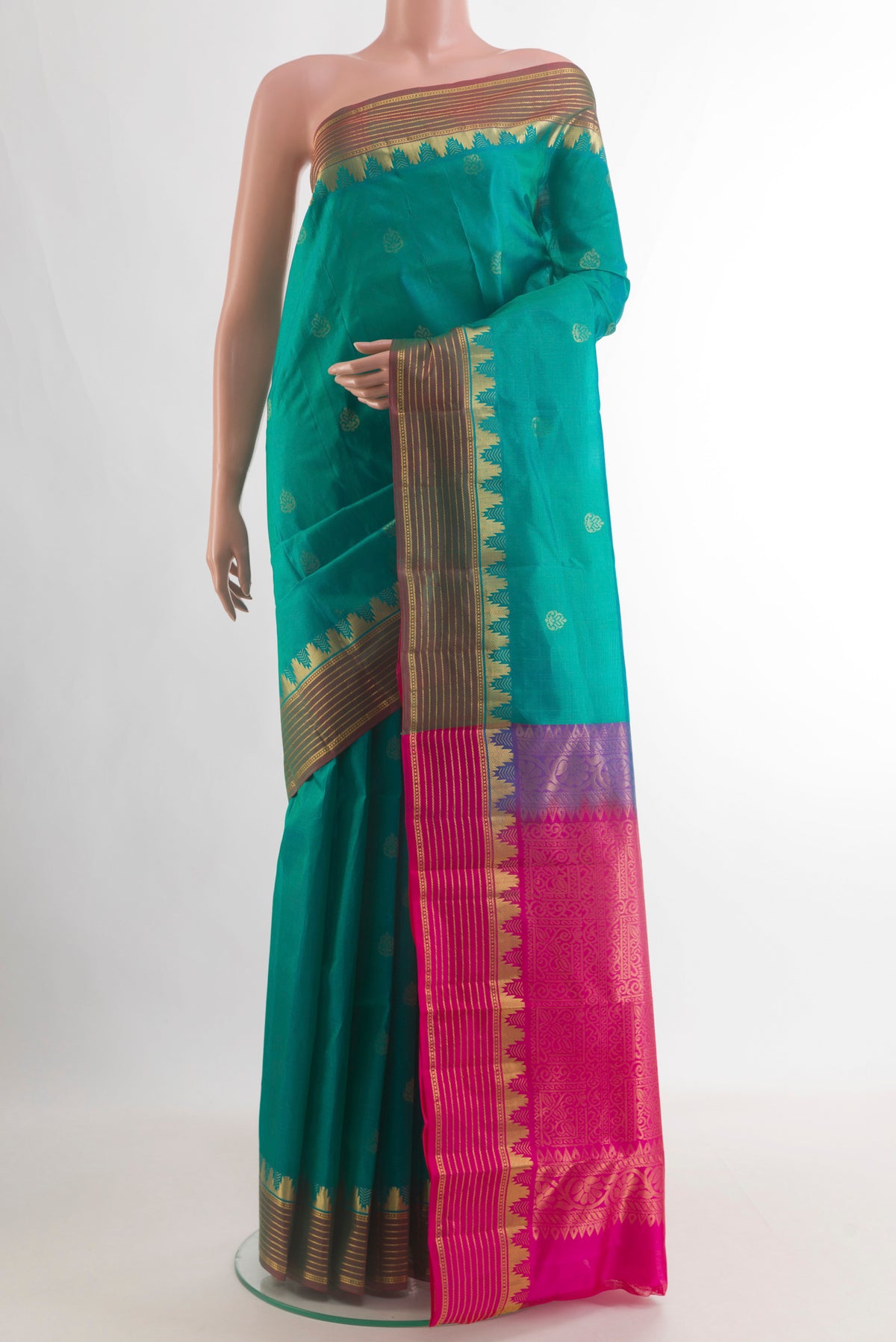 Pure Silk Turquoise Kanjivaram Saree with Zari Butta on the body and Zari Border.  displayed on a mannequin
