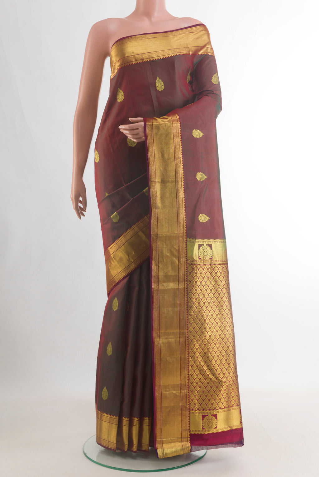 Pure Silk Green with Maroon Color Kanchipuram Saree with Zari Butta on the body and Zari Border.  displayed on a mannequin