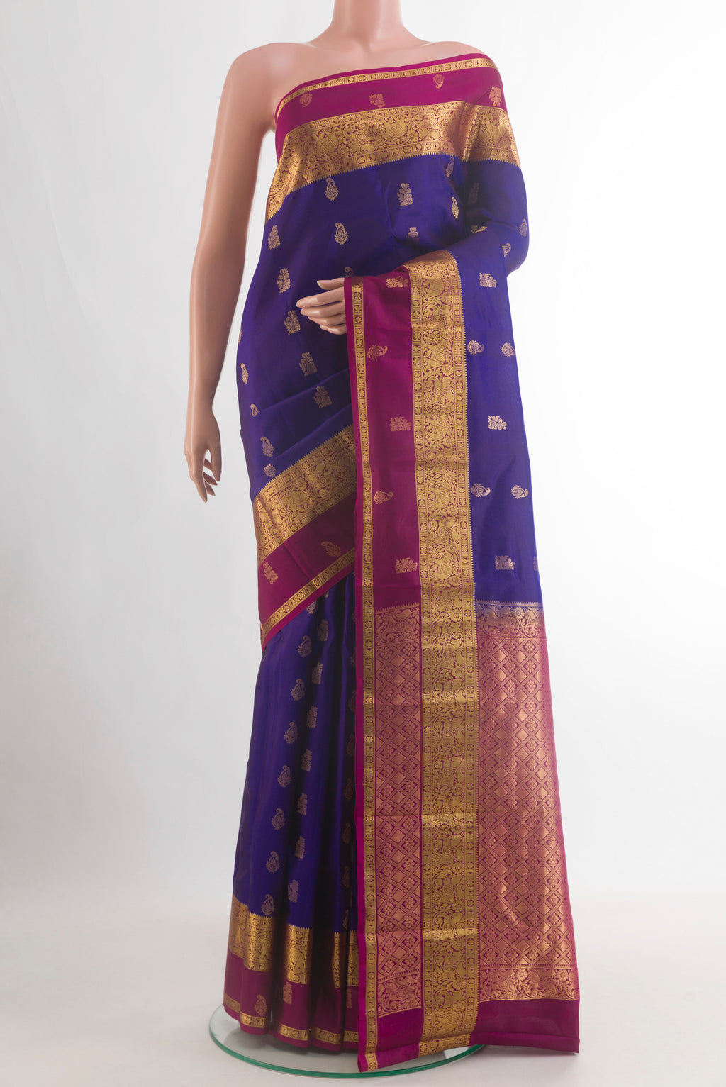 Pure Silk Blue Kanchipuram Saree with Zari Butta on the body and Zari Border.  displayed on a mannequin