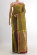 Pure Silk Mehandi Green Kanchipuram Saree with Zari Butta on the body and Zari Border.  displayed on a mannequin