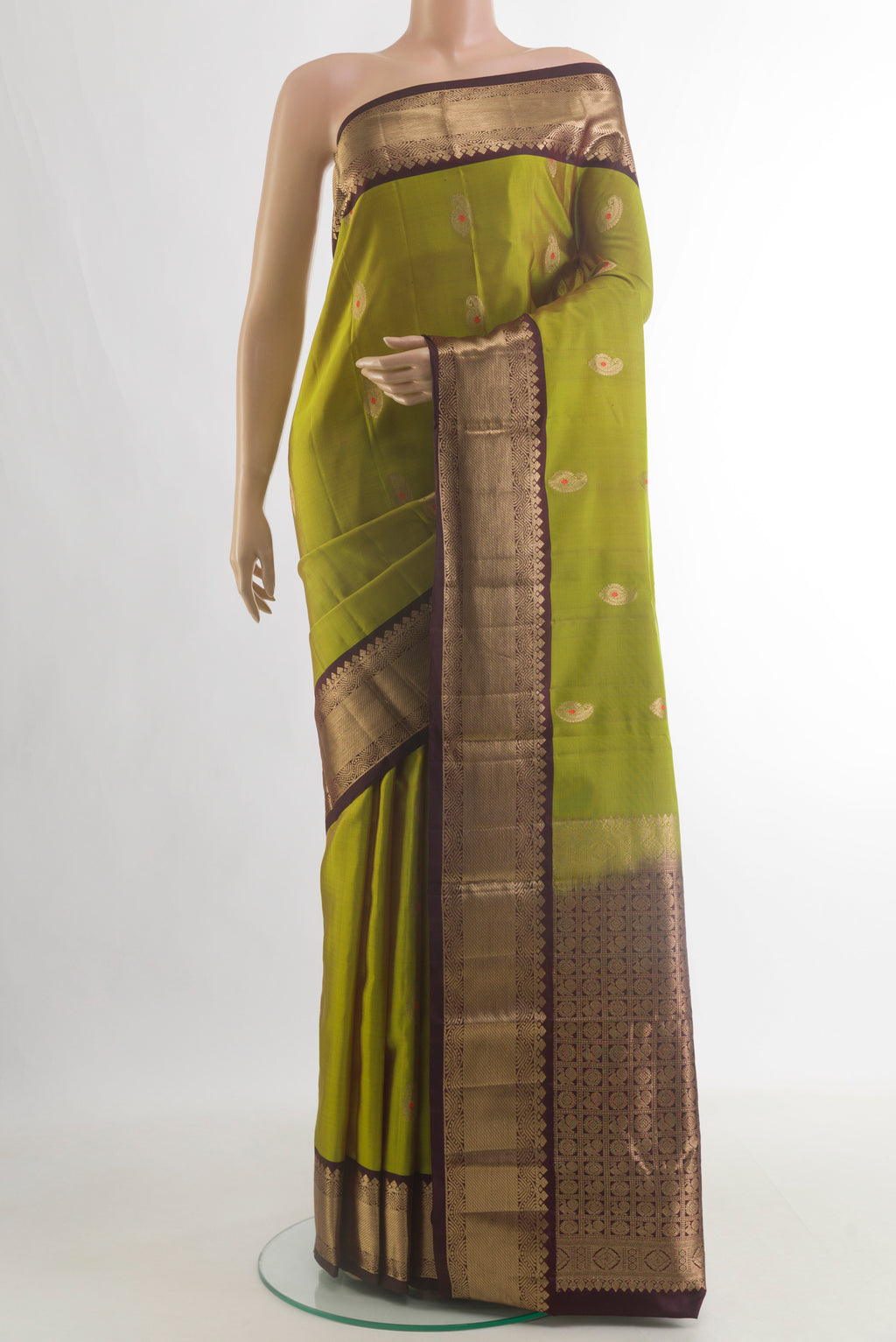Pure Silk Mehandi Green Kanchipuram Saree with Zari Butta on the body and Zari Border.  displayed on a mannequin