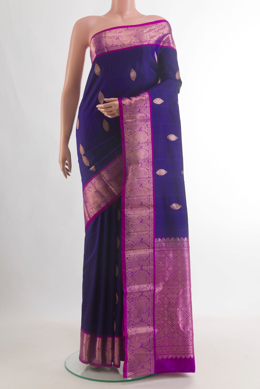 Pure Silk Dark Blue Kanchipuram Saree with Zari Butta on the body and Zari Border.  displayed on a mannequin