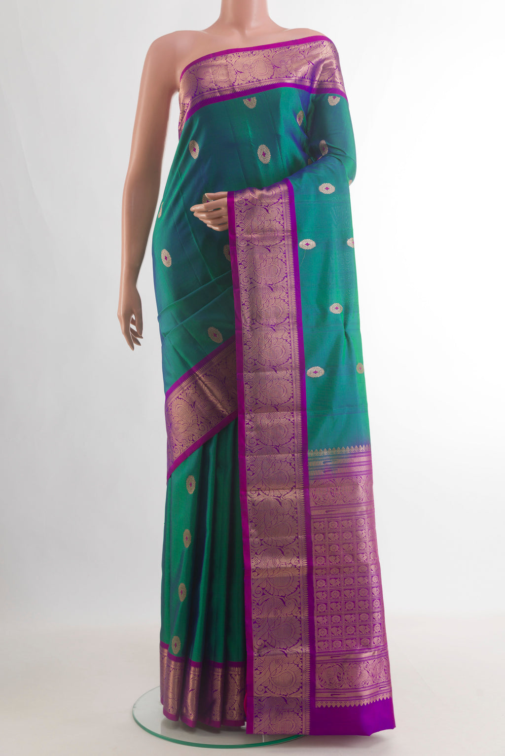 Pure Silk Peacock Blue Kanchipuram Saree with Zari Butta on the body and Zari Border.  displayed on a mannequin