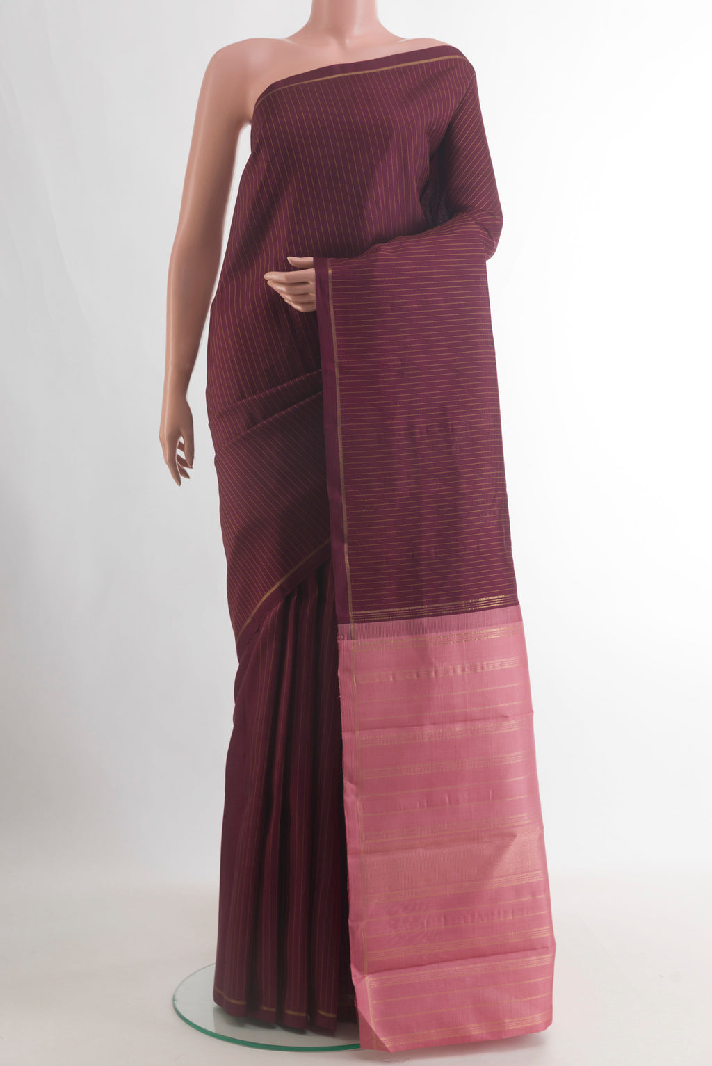 Pure Silk Brown Kanjivaram Saree with Stripes on the body and Thin Zari Line.  displayed on a mannequin
