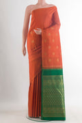 Pure Silk Pure Zari Brick Orange Kanchipuram Saree with Zari Butta on the body and Zari Border.  displayed on a mannequin