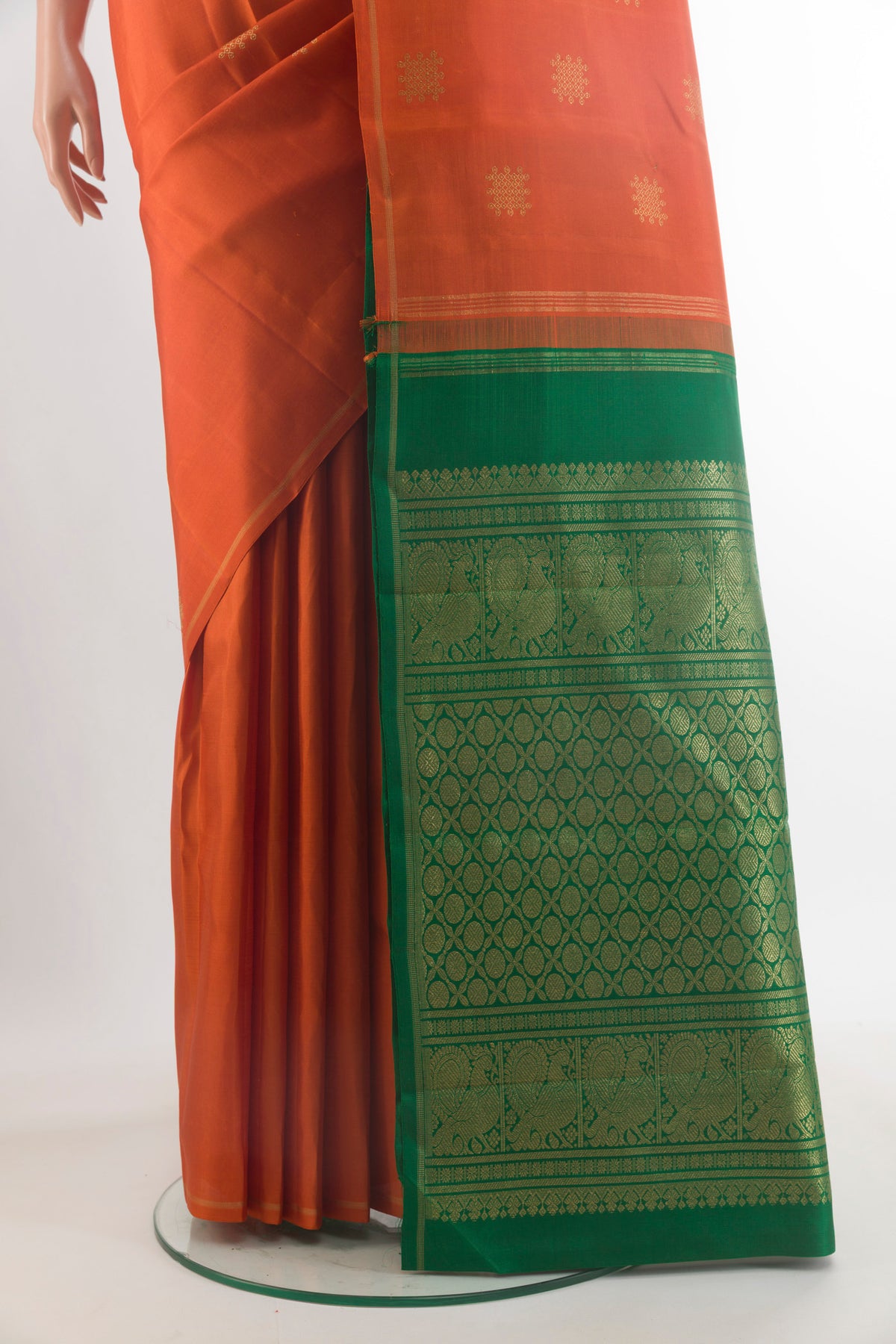 Pleats and pallu of Pure Silk Pure Zari Brick Orange Kanchipuram Saree with Zari Butta on the body and Zari Border. 