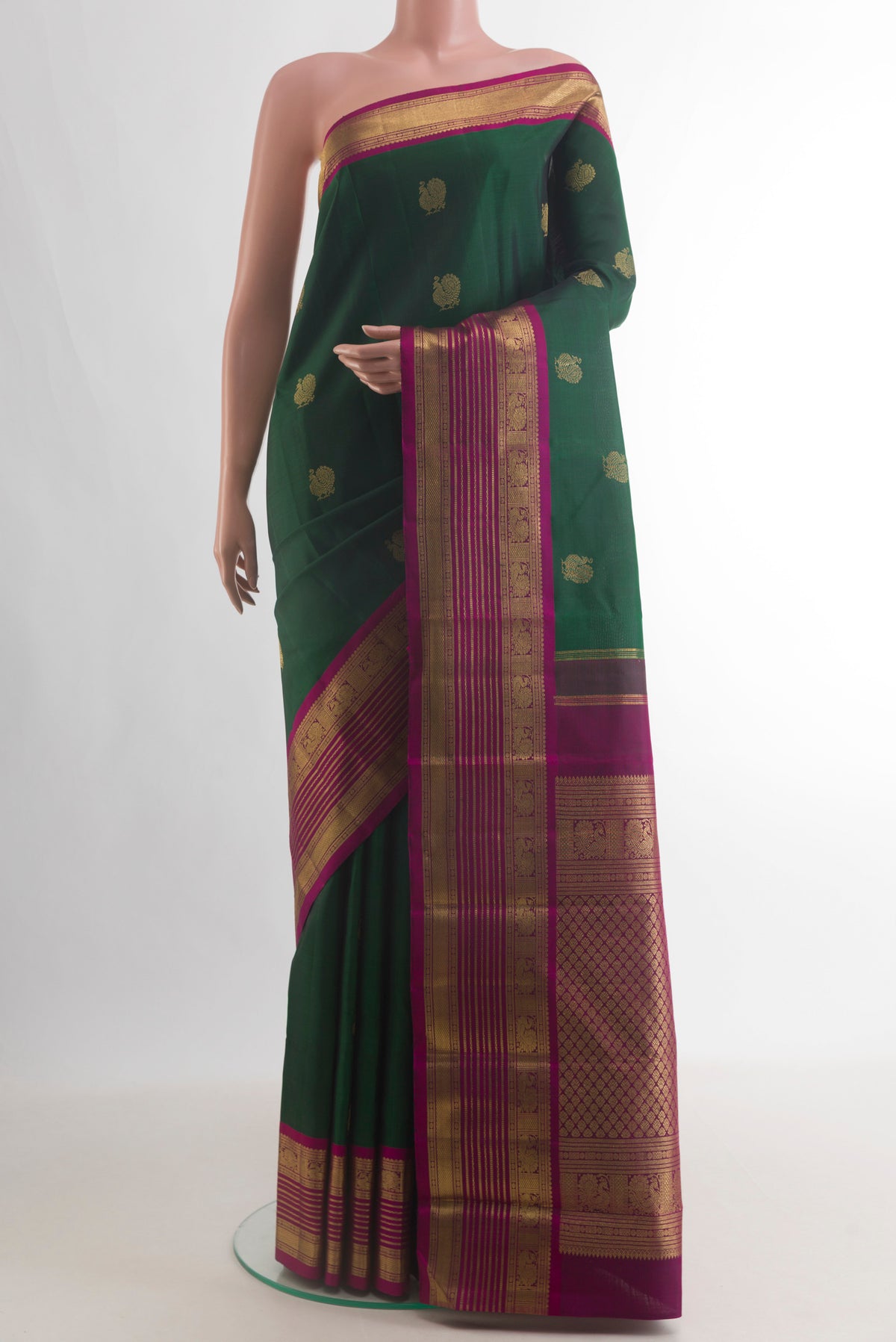 Pure Silk Pure Zari Green Kanjivaram Saree with Zari Butta on the body and Zari Border.  displayed on a mannequin