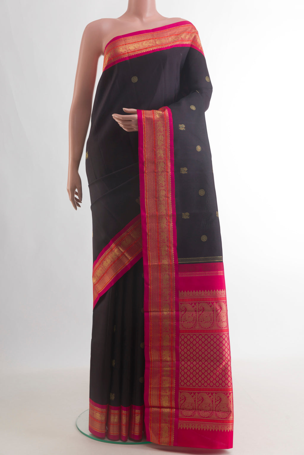 Pure Silk Black Kanjivaram Saree with Zari Butta on the body and Zari Border.  displayed on a mannequin