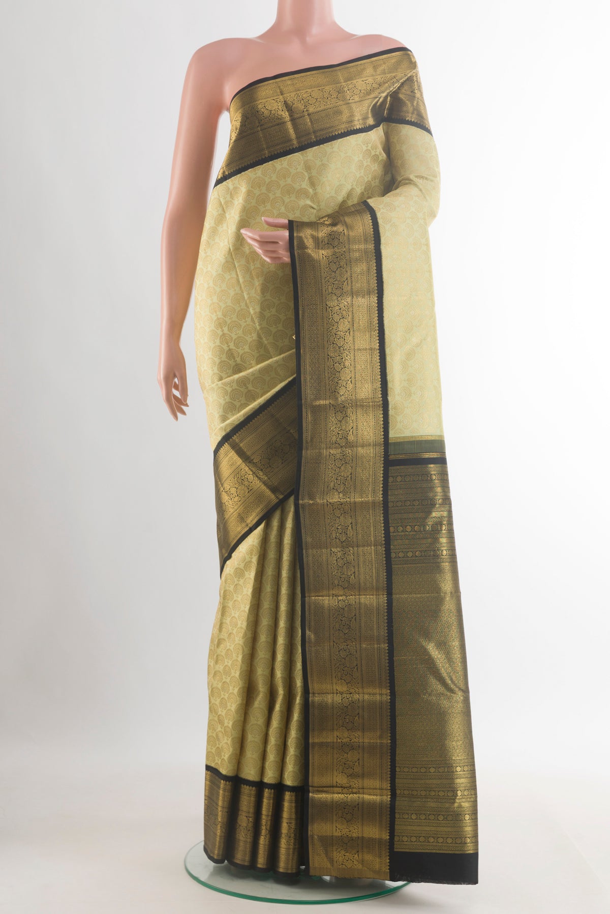 Pure Silk Cream Kanjivaram Saree with Zari Brocade on the body and Zari Border.  displayed on a mannequin