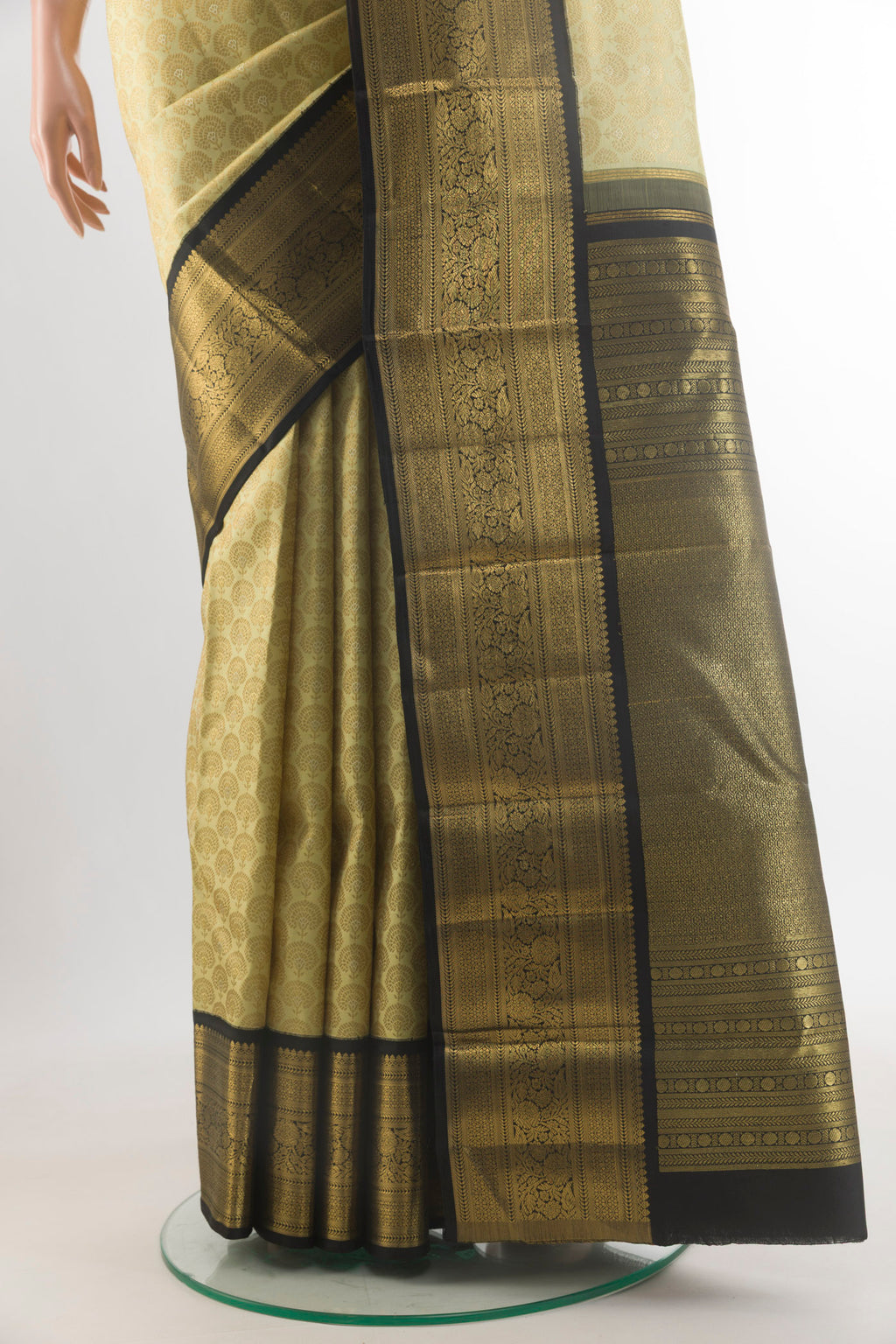 Pleats and pallu of Pure Silk Cream Kanjivaram Saree with Zari Brocade on the body and Zari Border. 