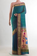 Pure Silk Peacock Blue Dual Tone Paithani Saree with Zari Butta on the body and Zari Border.  displayed on a mannequin