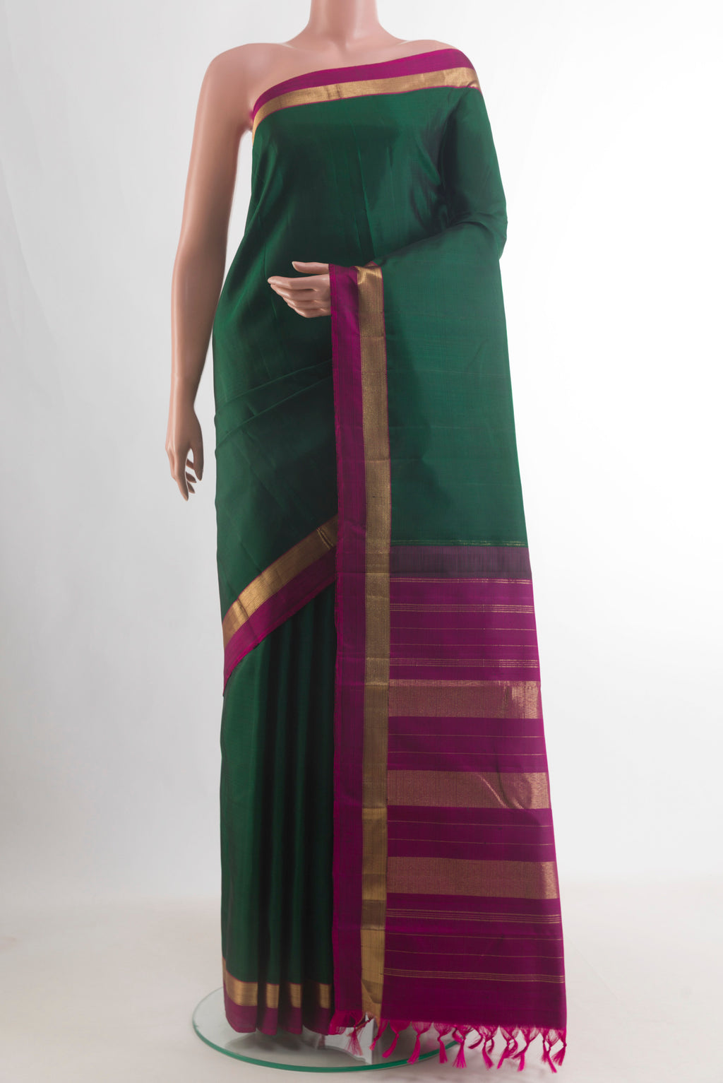 Pure Silk Bottle Green Kanjivaram Saree with Plain Body and Zari Border.  displayed on a mannequin
