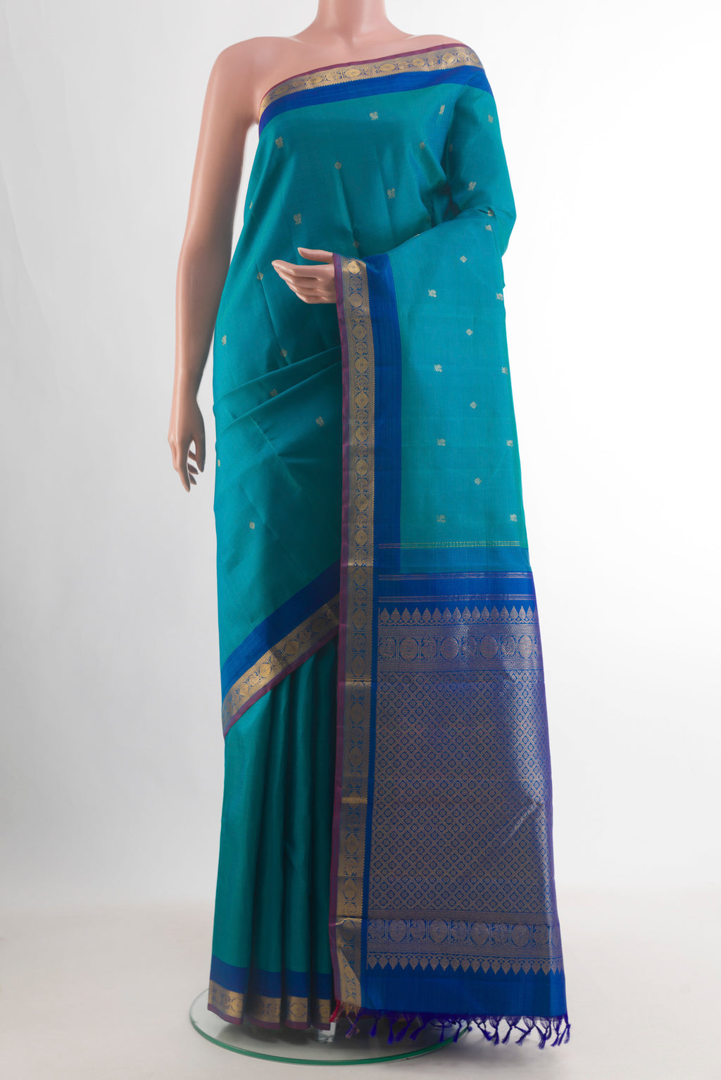 Pure Silk Blue Kanchipuram Saree with Zari Butta on the body and Zari Border.  displayed on a mannequin