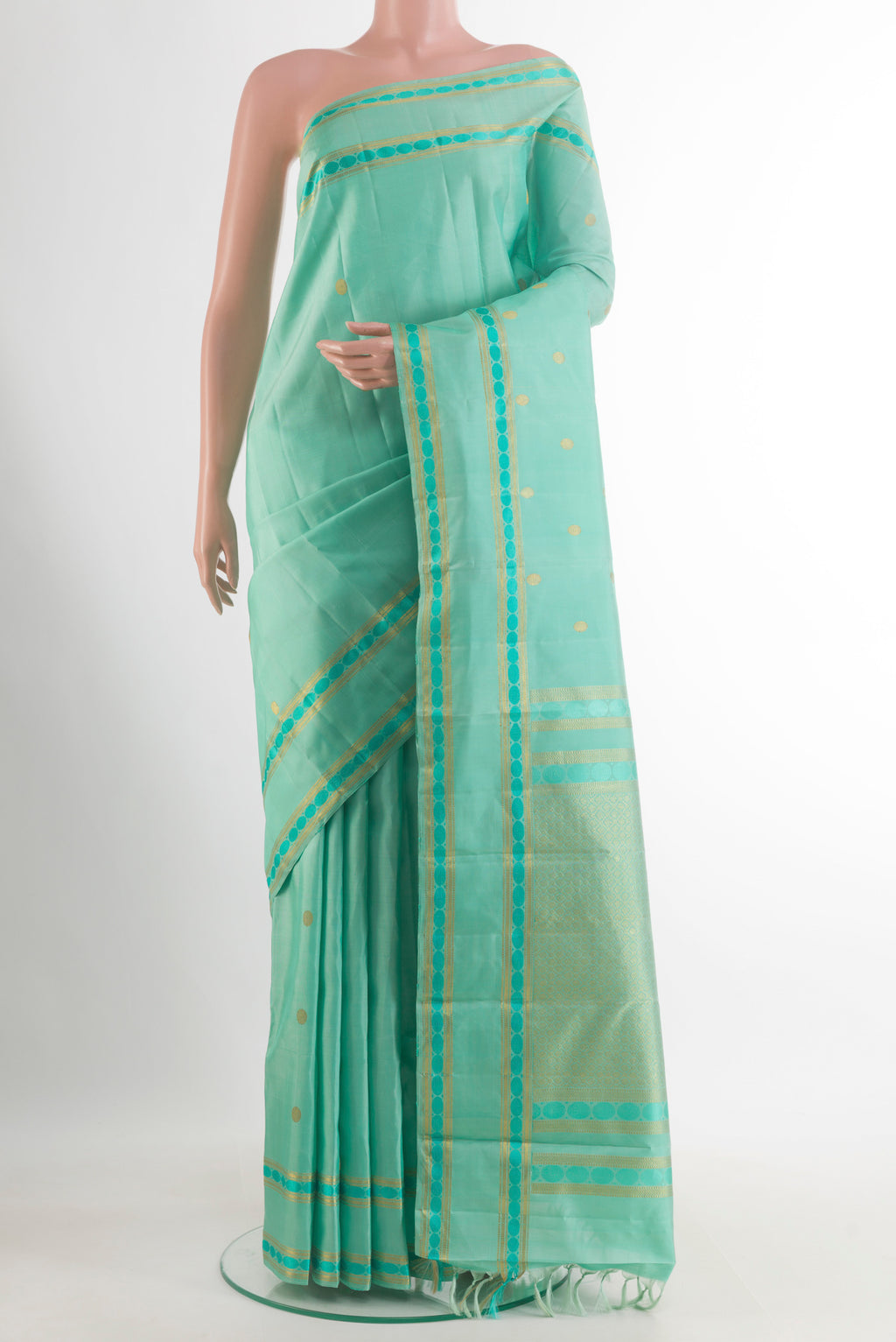 Pure Silk Sea Green Kanjivaram Saree with Zari Butta on the body and Zari Border.  displayed on a mannequin