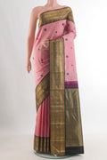 Pure Silk Coral Kanjivaram Saree with Thread Butta on the body and Zari Border.  displayed on a mannequin