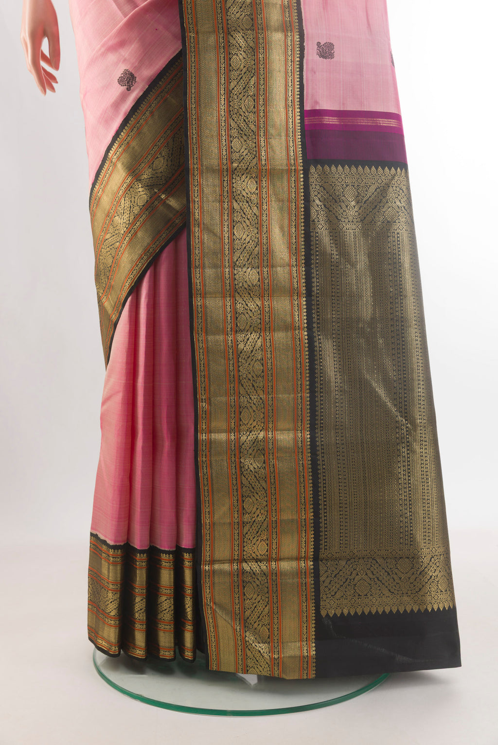 Pleats and pallu of Pure Silk Coral Kanjivaram Saree with Thread Butta on the body and Zari Border. 