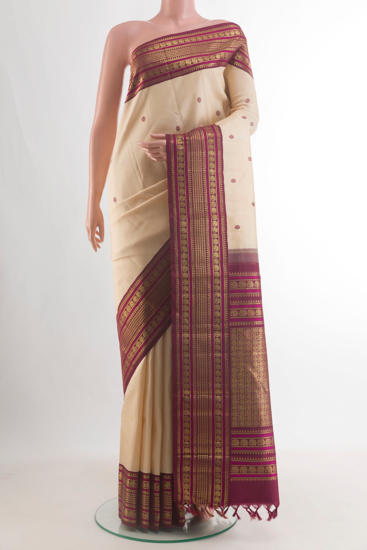 Pure Silk Cream Kanjivaram Saree with Thread Butta on the body and Zari Border.  displayed on a mannequin