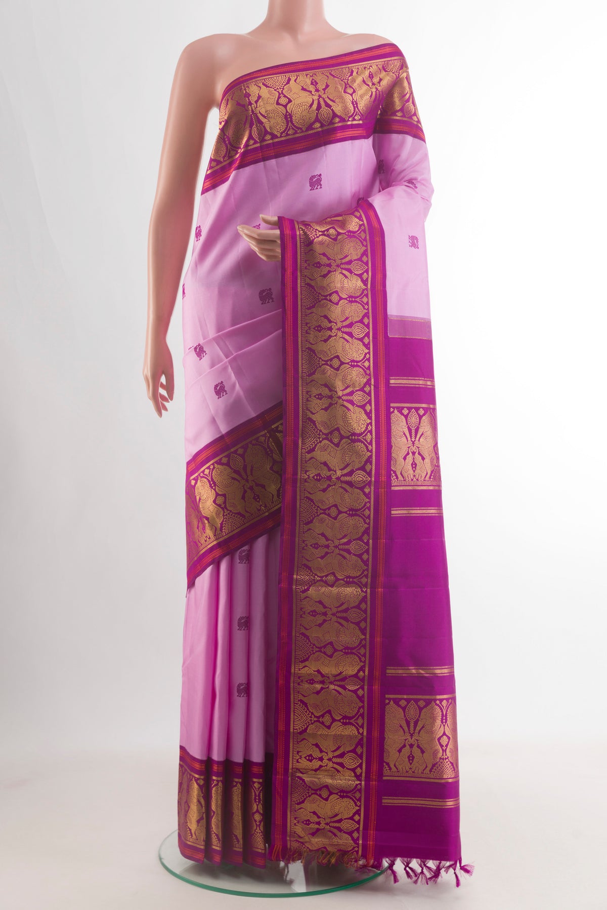 Pure Silk Rose pink Kanjivaram Saree with Thread Butta on the body and Zari Border.  displayed on a mannequin