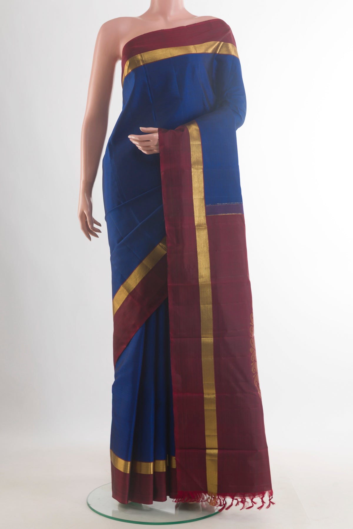 Pure Silk Blue Kanchipuram Saree with Plain Body and Zari Border.  displayed on a mannequin