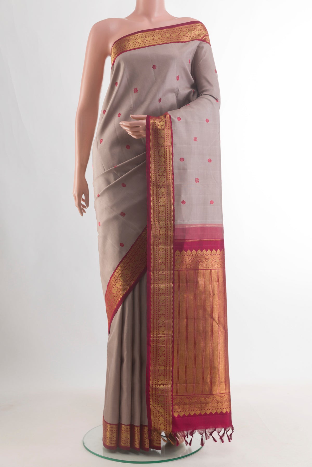 Pure Silk Grey Kanjivaram Saree with Thread Butta on the body and Zari Border.  displayed on a mannequin