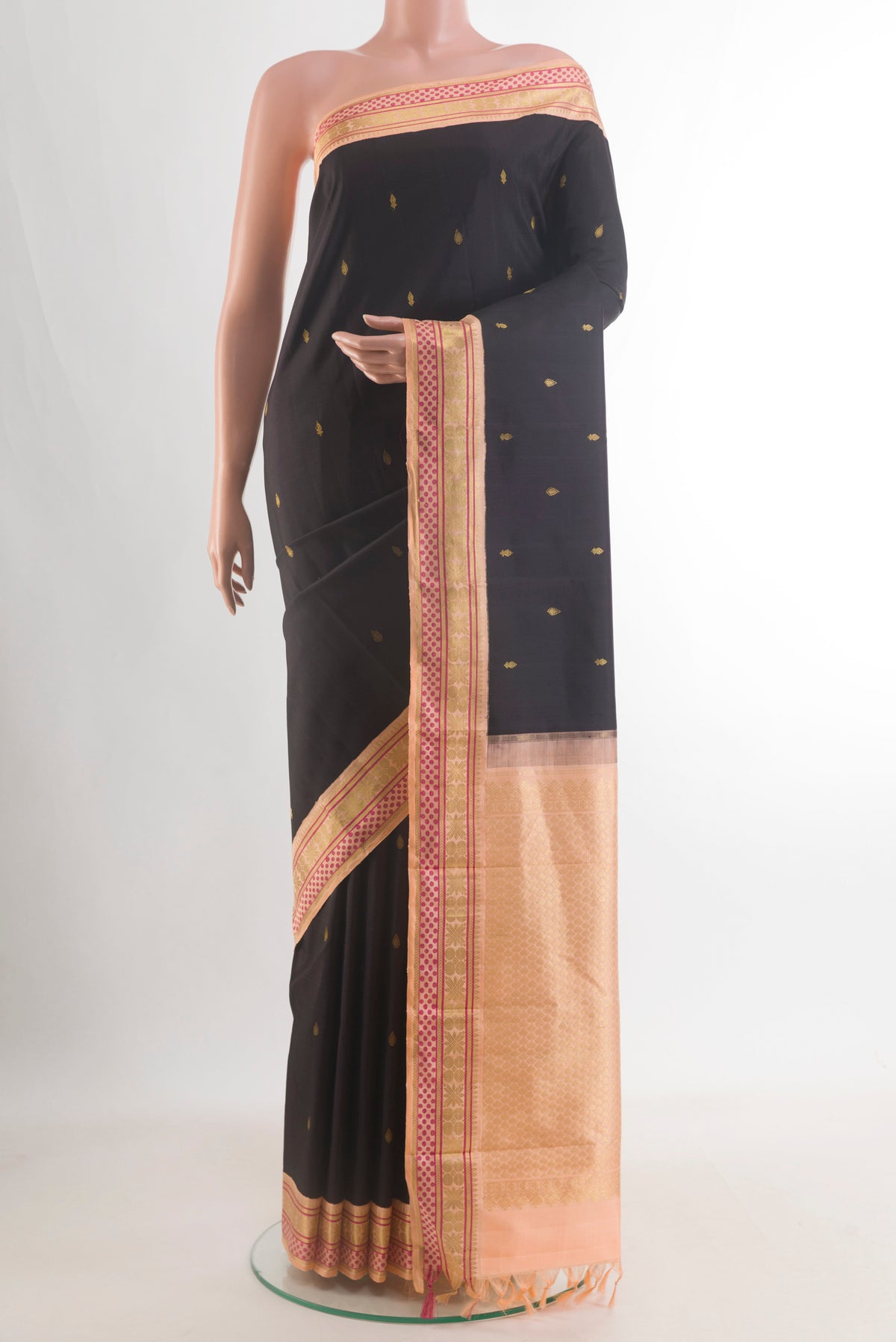 Pure Silk Black Kanjivaram Saree with Zari Butta on the body and Zari Border.  displayed on a mannequin