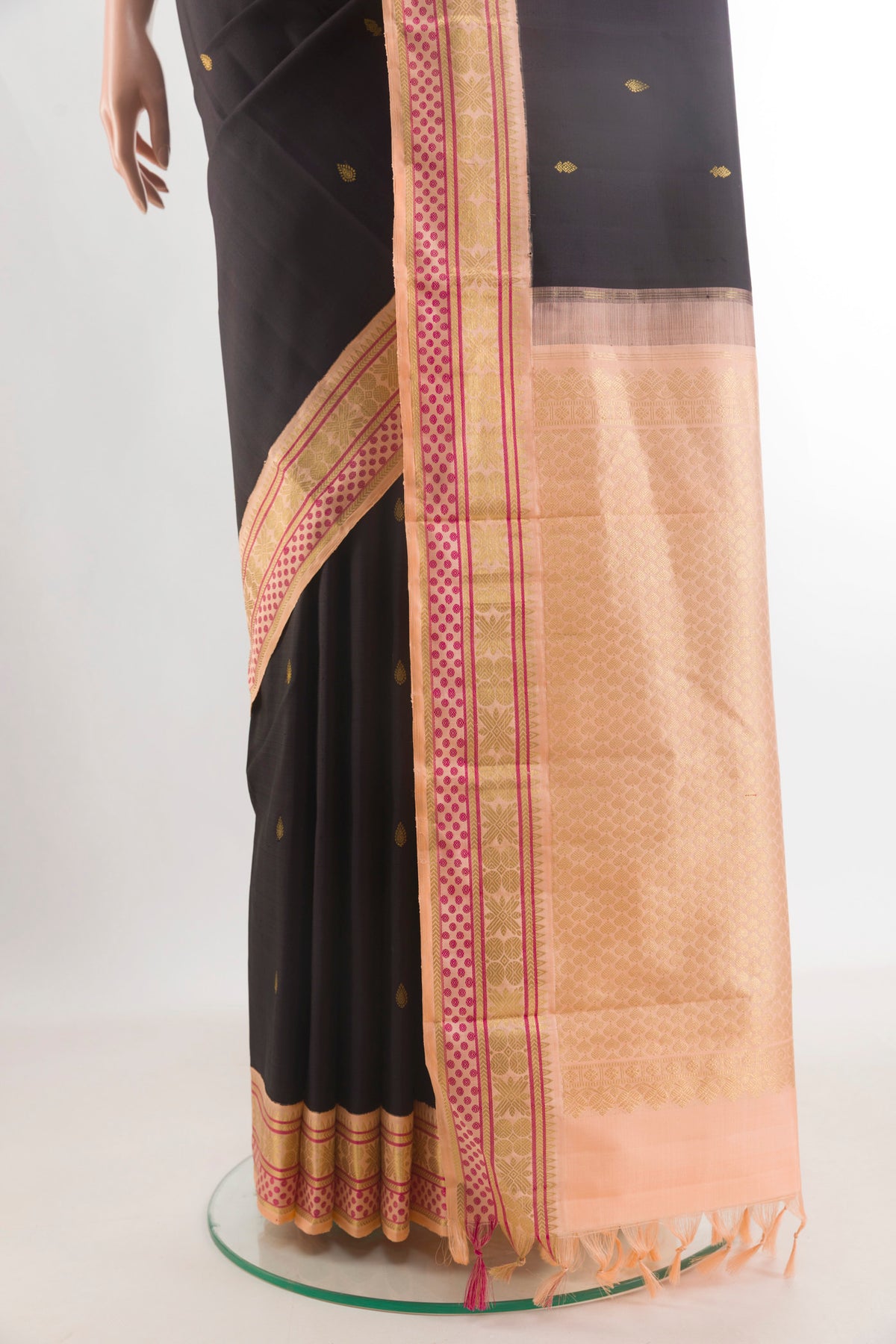 Pleats and pallu of Pure Silk Black Kanjivaram Saree with Zari Butta on the body and Zari Border. 