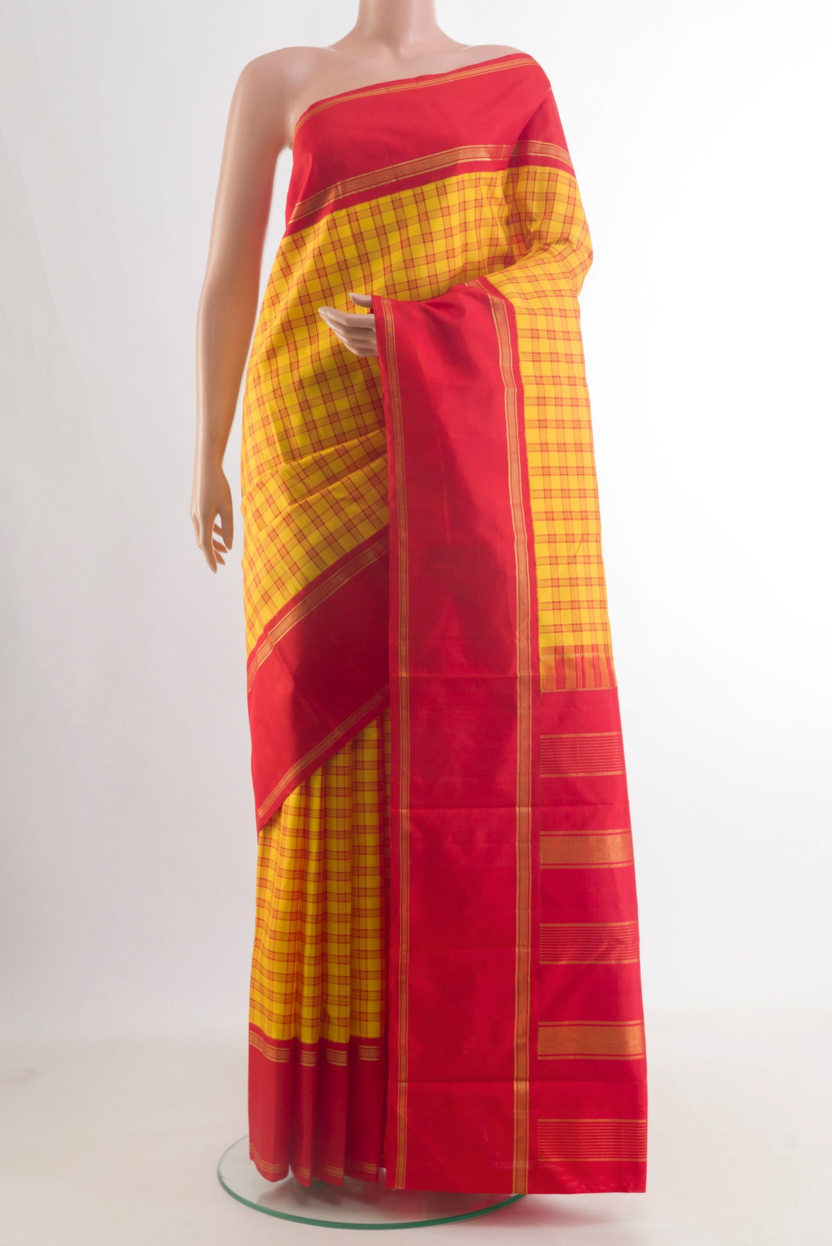 Pure Silk Yellow Kanjivaram Saree with Checked design on the body and Plain Border.  displayed on a mannequin