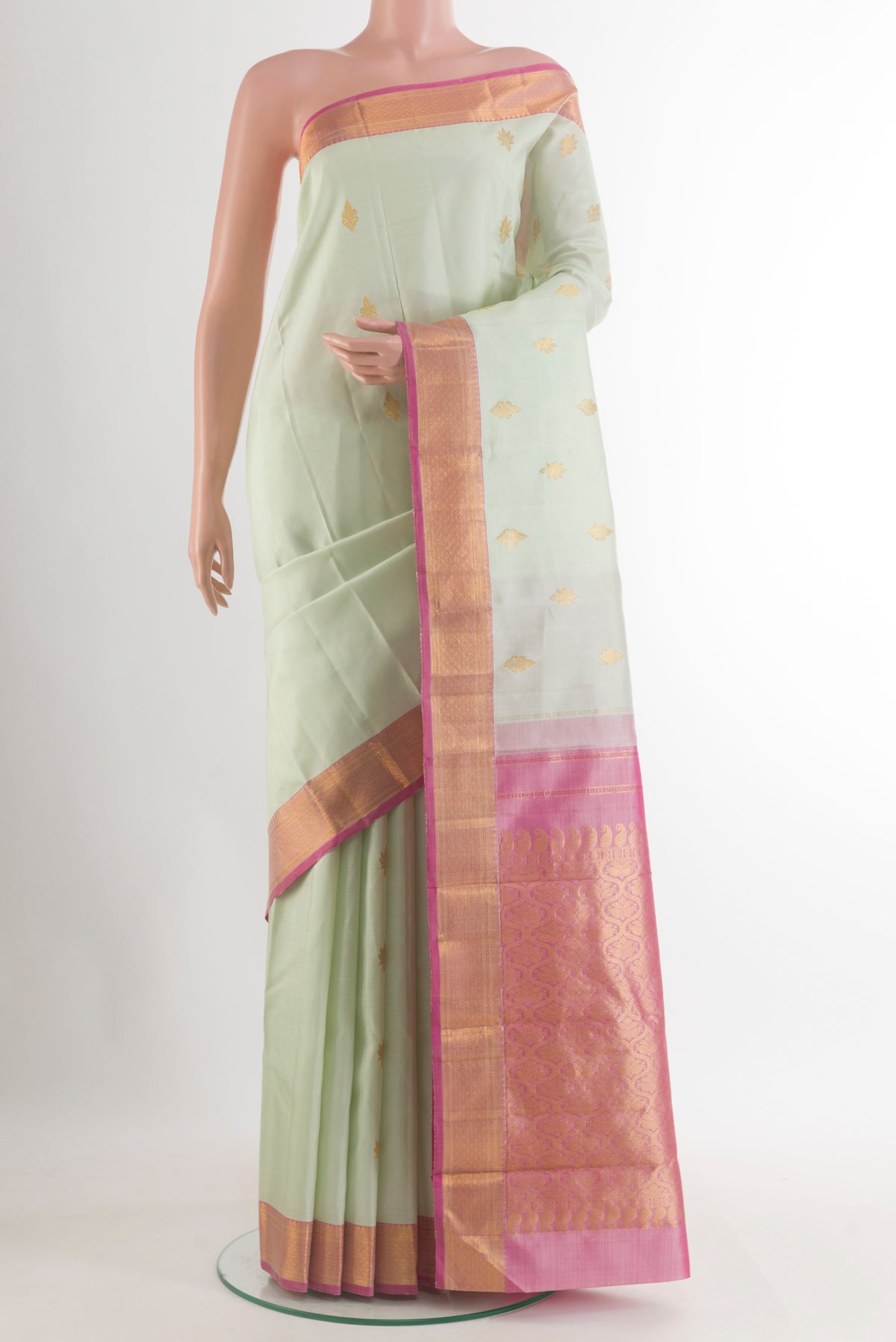 Pure Silk Light Green Kanchipuram Saree with Zari Butta on the body and Zari Border.  displayed on a mannequin