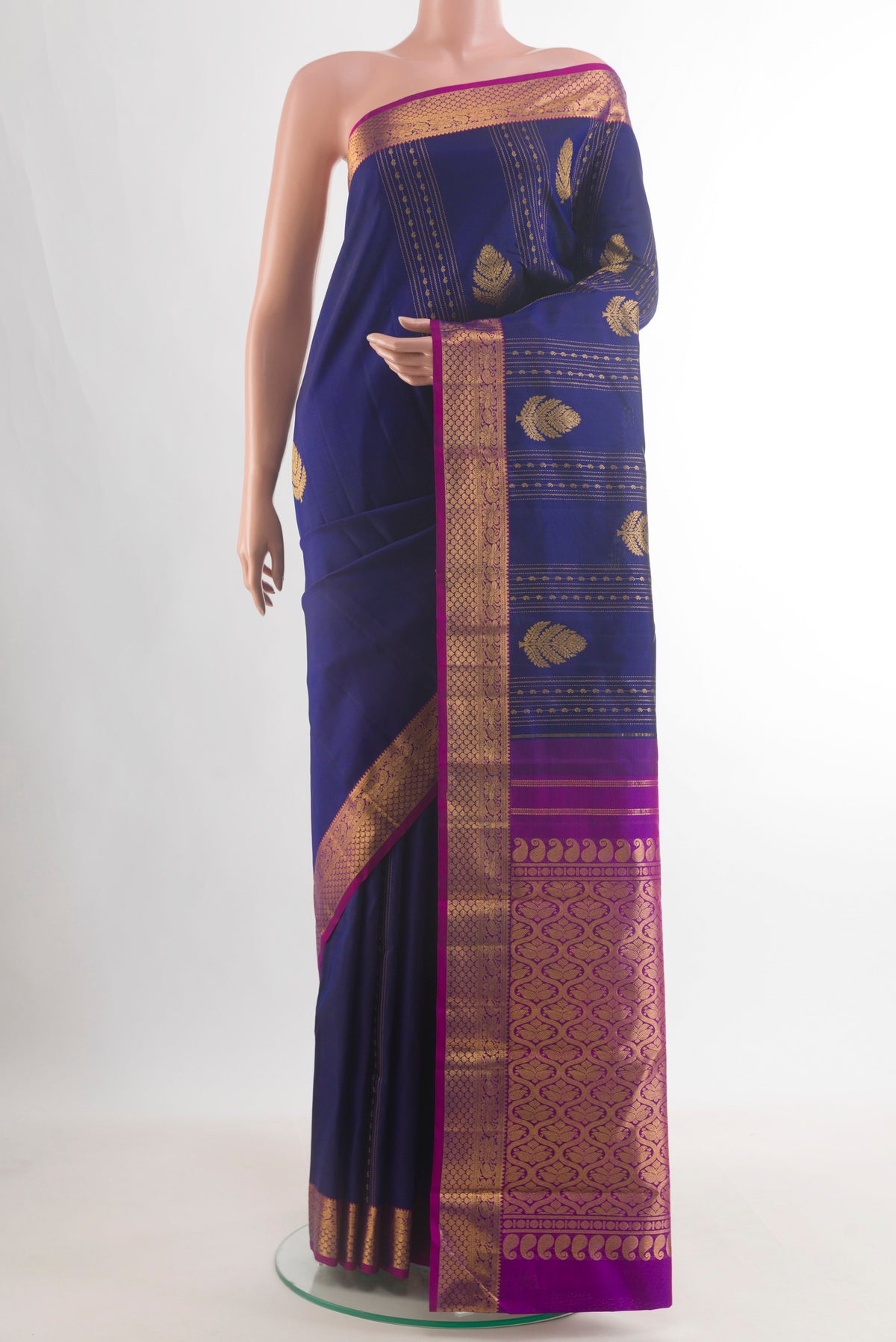 Pure Silk Navy Blue Kanjivaram Saree with Zari Butta on the body and Zari Border.  displayed on a mannequin
