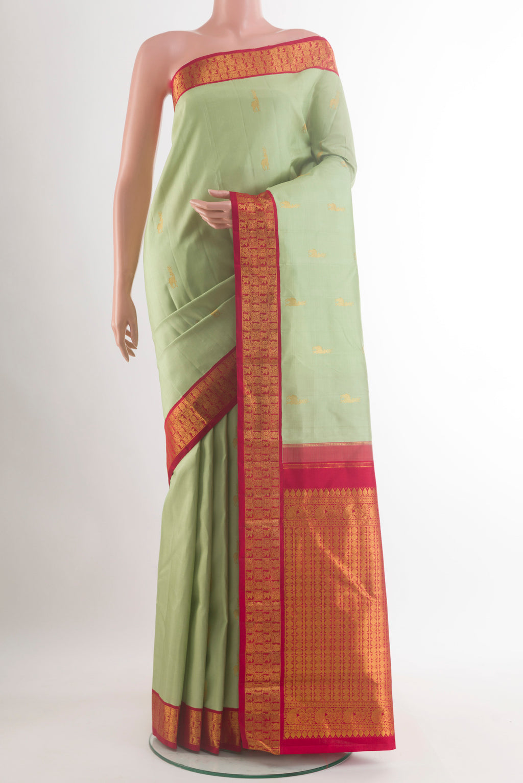Pure Silk Pista Green Kanjivaram Saree with Zari Butta on the body and Zari Border.  displayed on a mannequin
